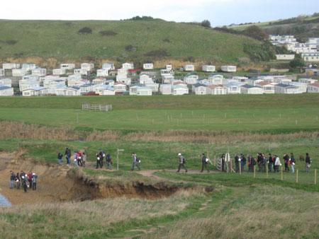 group of students head for the cliffs along part of the jurassic coast, dorset