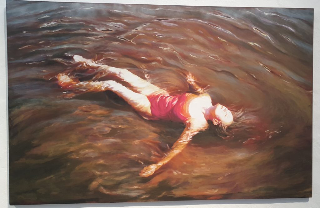 A painting of a woman lying in rippling water